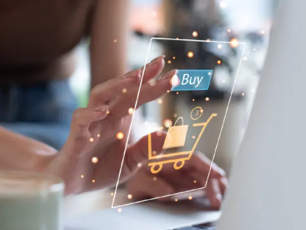 A person holding an electronic device with the word buy on it.