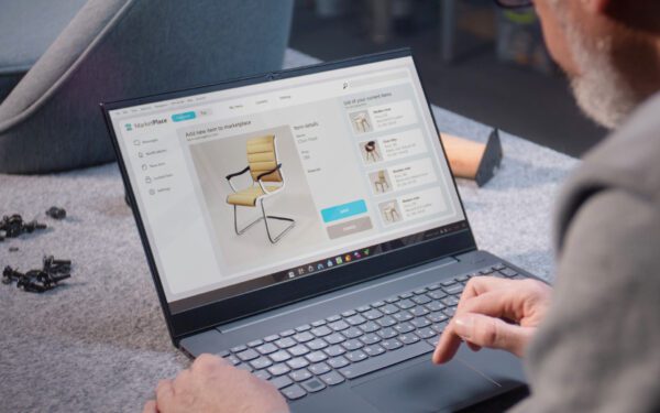 A person using a laptop on top of a table.