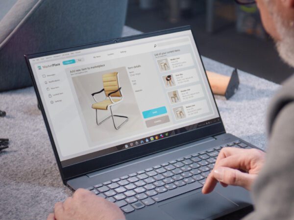 A person using a laptop on top of a table.